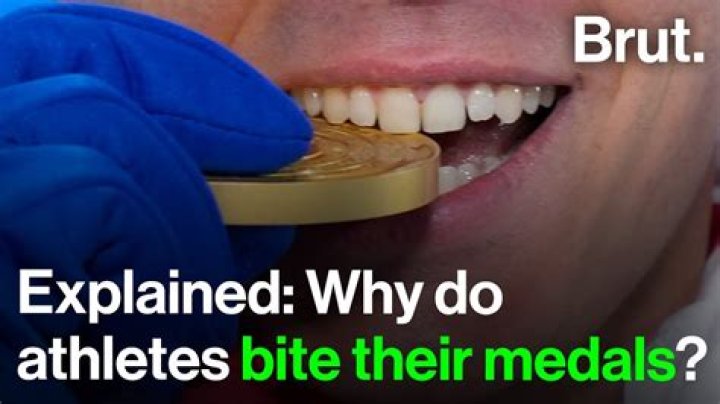 Why athletes bite their medals?